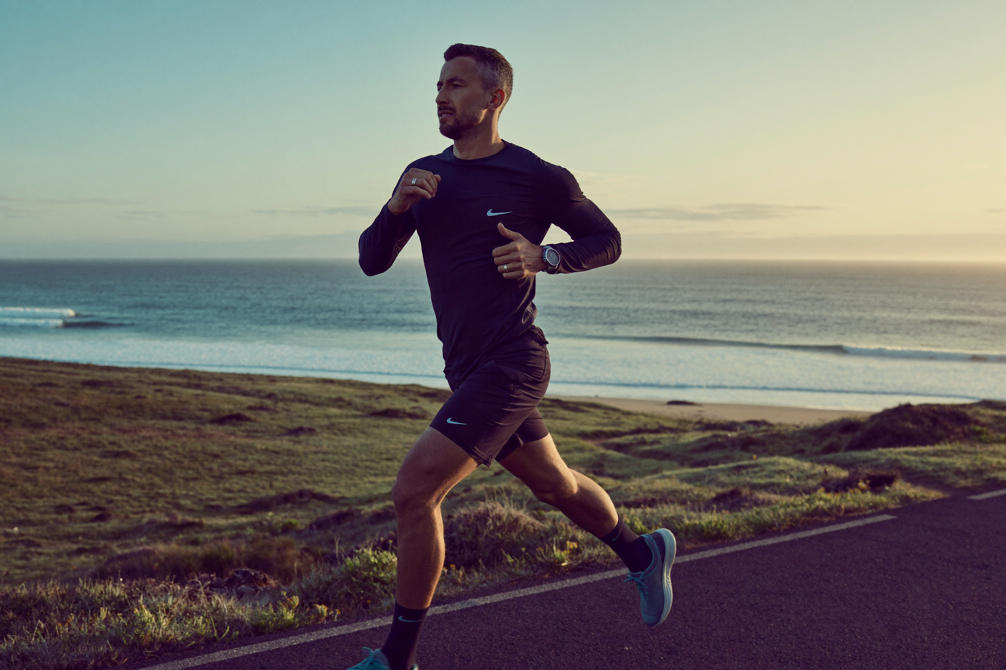 Man running along the coast at sunrise