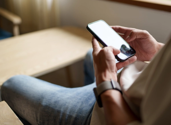 Person completing pre-screening on their phone